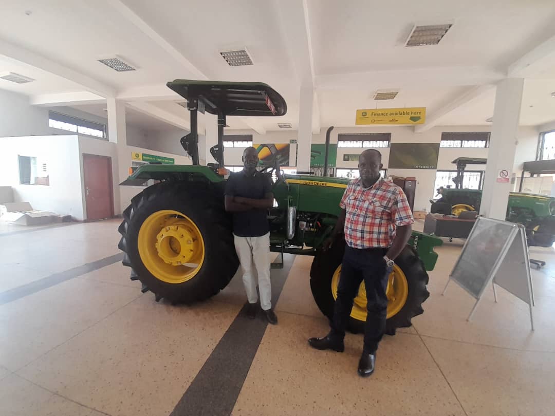 NUTOFA leadership inspecting a John Deere tractor in Gulu